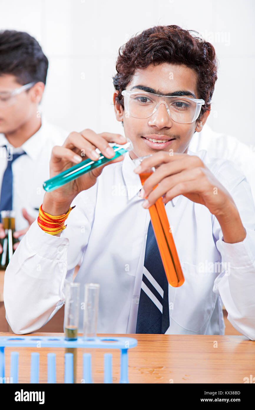 Teenage School Boy Doing Experiment Chemical Liquid In Lab Stock Photo