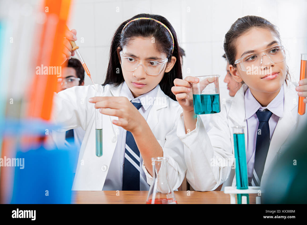 Indian High School Girls Students Doing Chemical Experiment Research laboratory Stock Photo