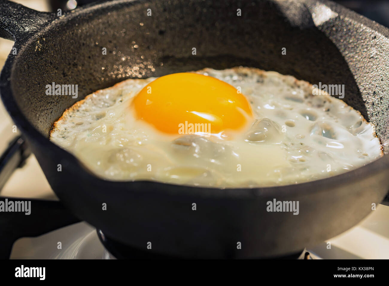 Close-up of fried eggs in a frying pan Stock Photo - Alamy