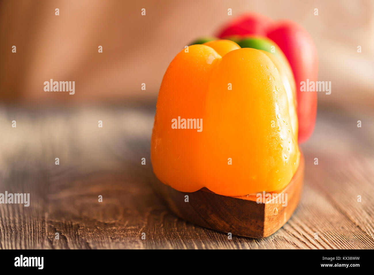 Variety of bell paprika peppers on cutting board Stock Photo - Alamy