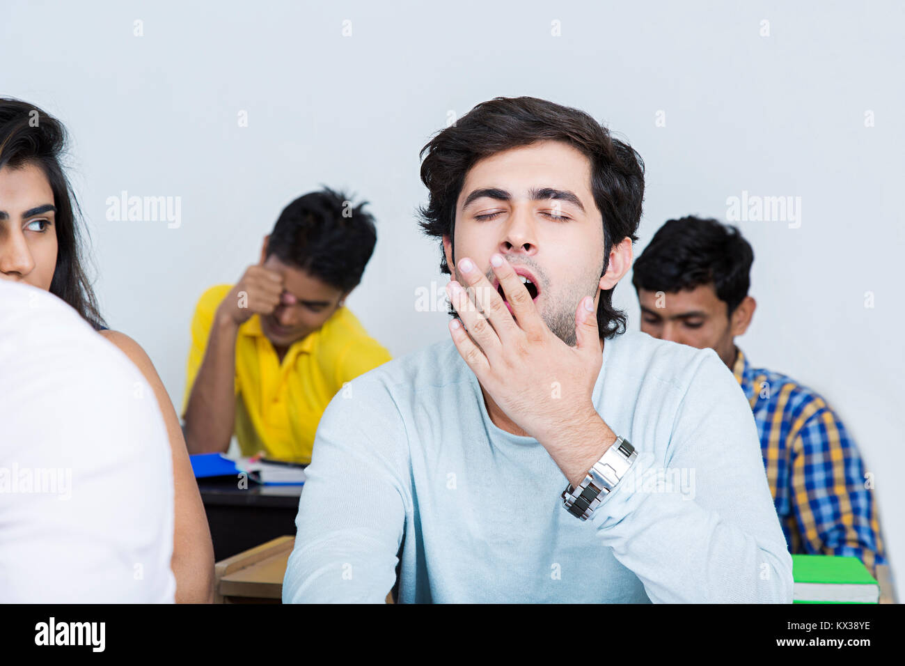 1 Indian College Young Man Student Yawning Sleeping In Class Stock Photo
