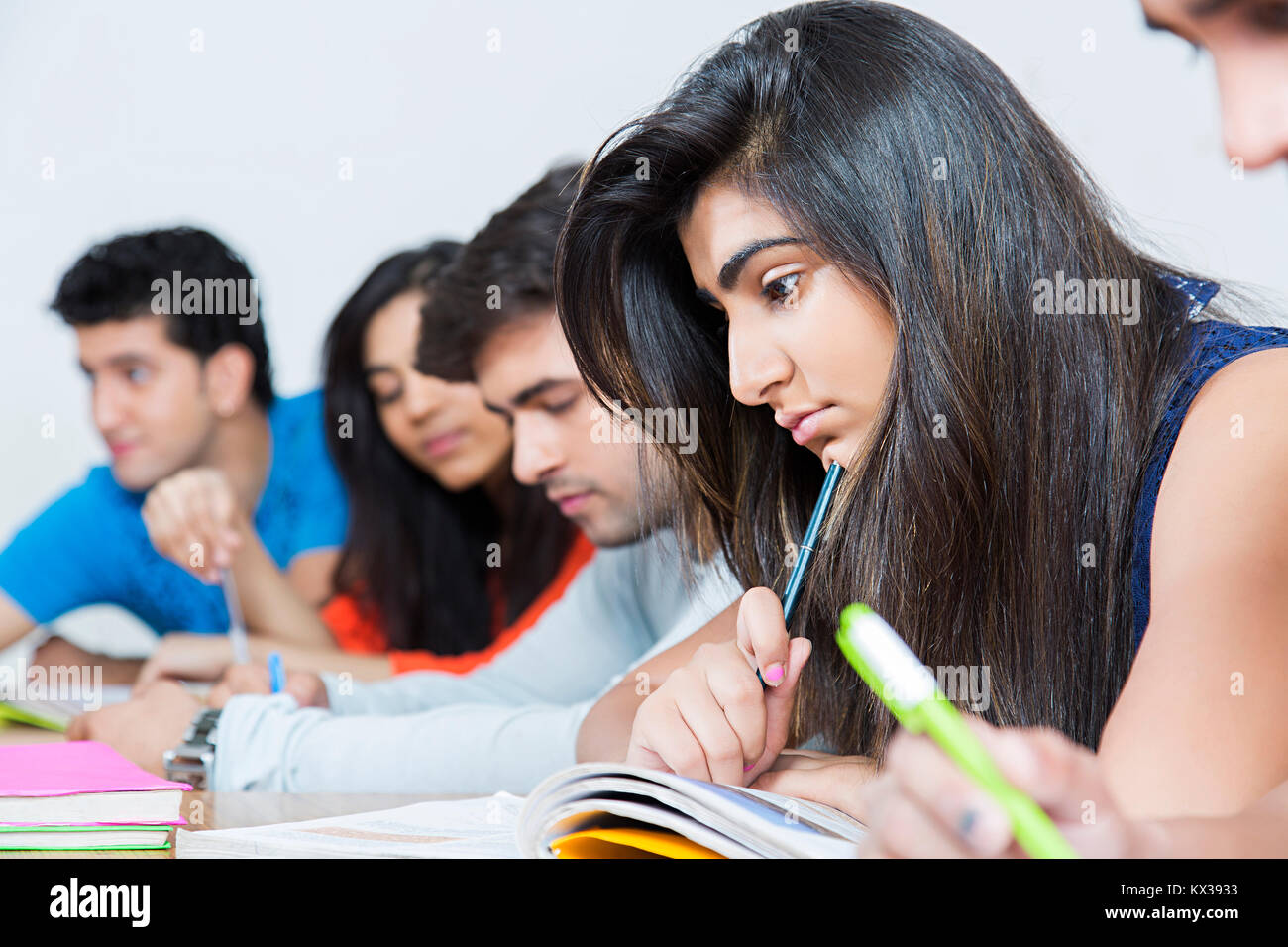 Group Indian College Students Reading Book Study Exam Preparation in Class Stock Photo