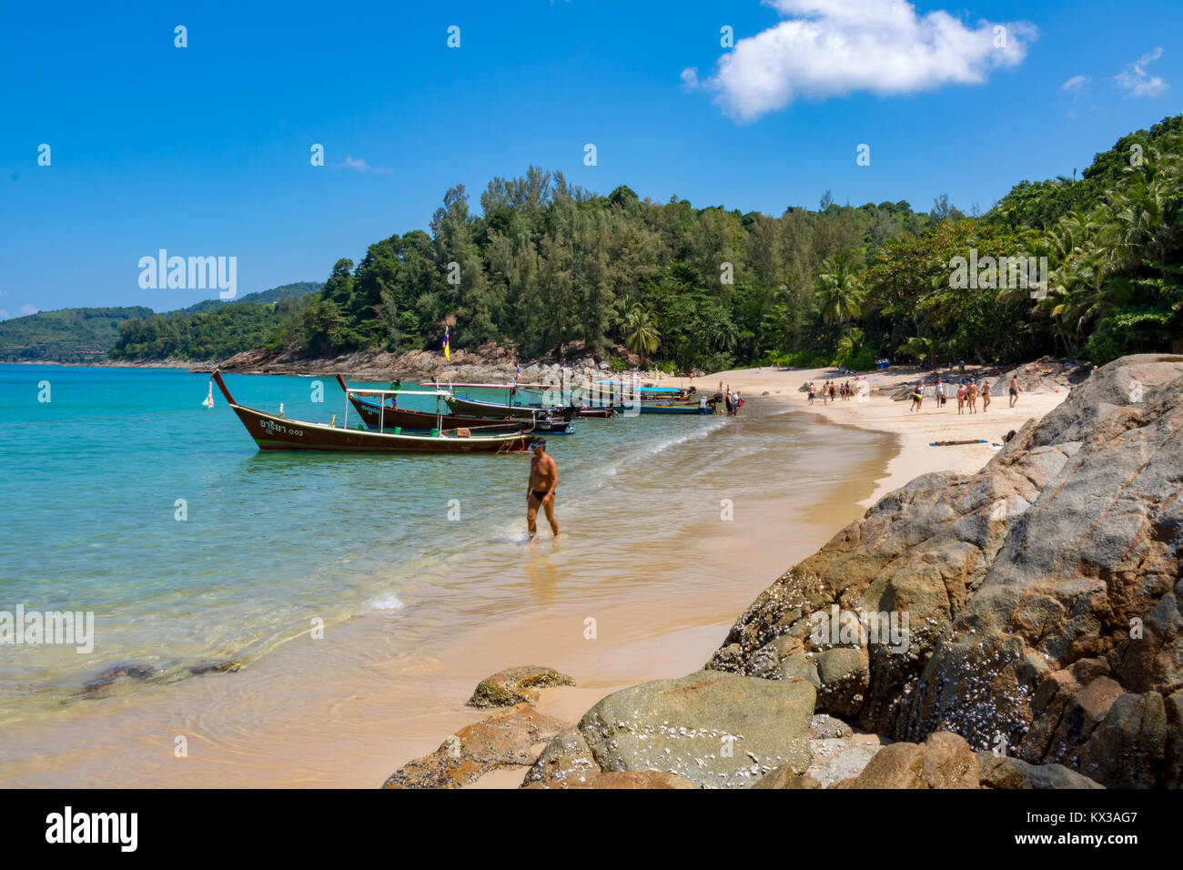 February 16, 2016 Layan Phuket Thailand Holiday makers enjoying themselves near the boats moored at Banana Beach Stock Photo