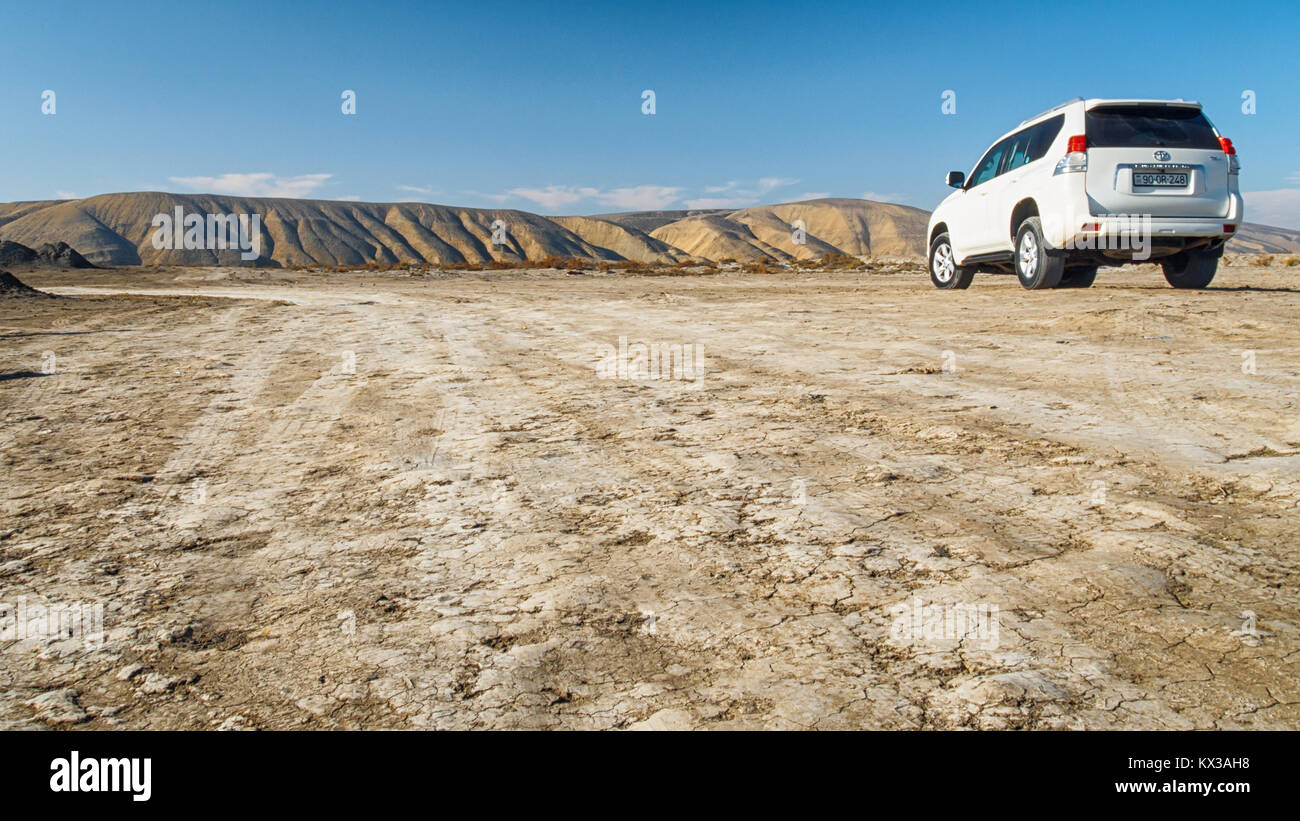 GOBUSTAN, AZERBAIJAN-DECEMBER 28, 2017: White Toyota Land Cruiser in the mud desert in Gobustan, Azerbaijan. Stock Photo