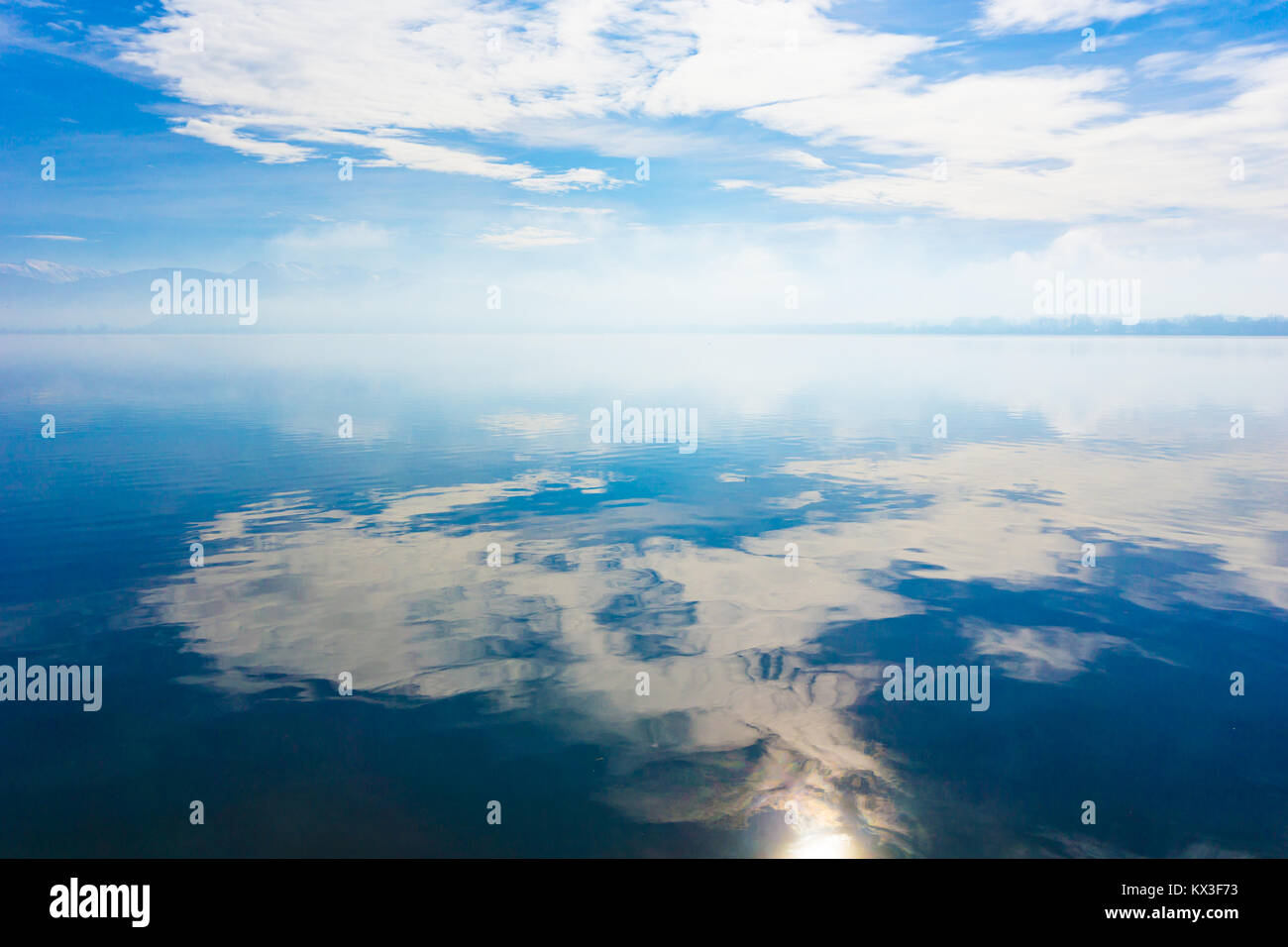 Total reflection of the blue sky with clouds in the lake of Ioannina (Lake Pamvotida) Stock Photo
