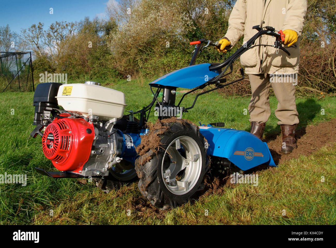 Rotavators in action in a country garden Stock Photo Alamy