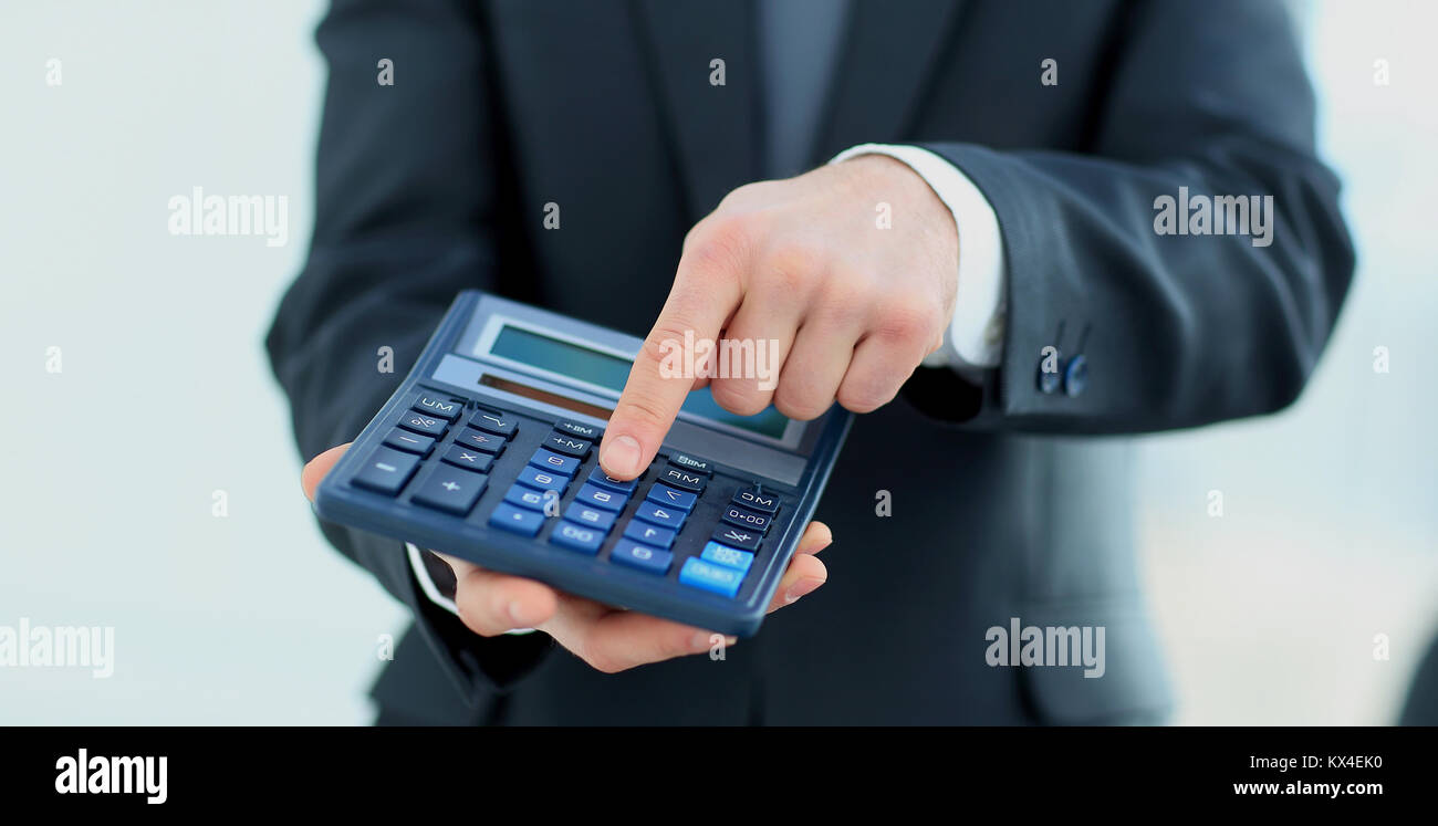 Manager Using Calculator businessman uses a calculator for calculations Stock Photo - Alamy