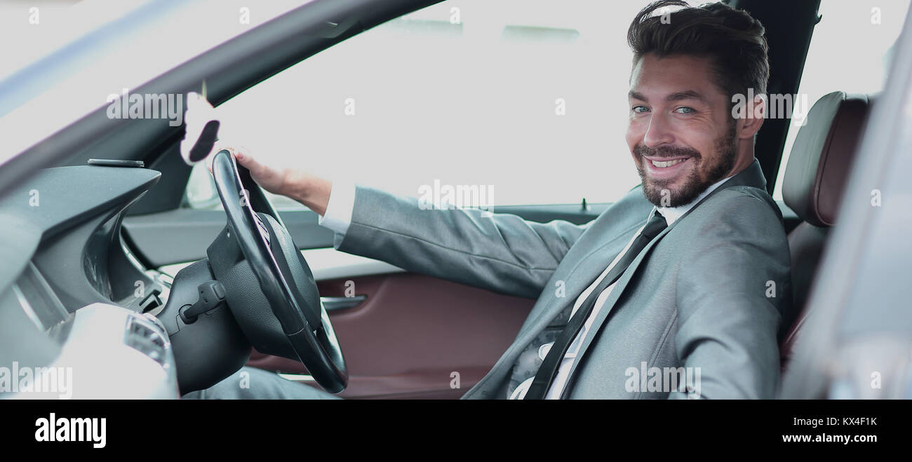 Portrait of an handsome smiling business man driving his car Stock ...