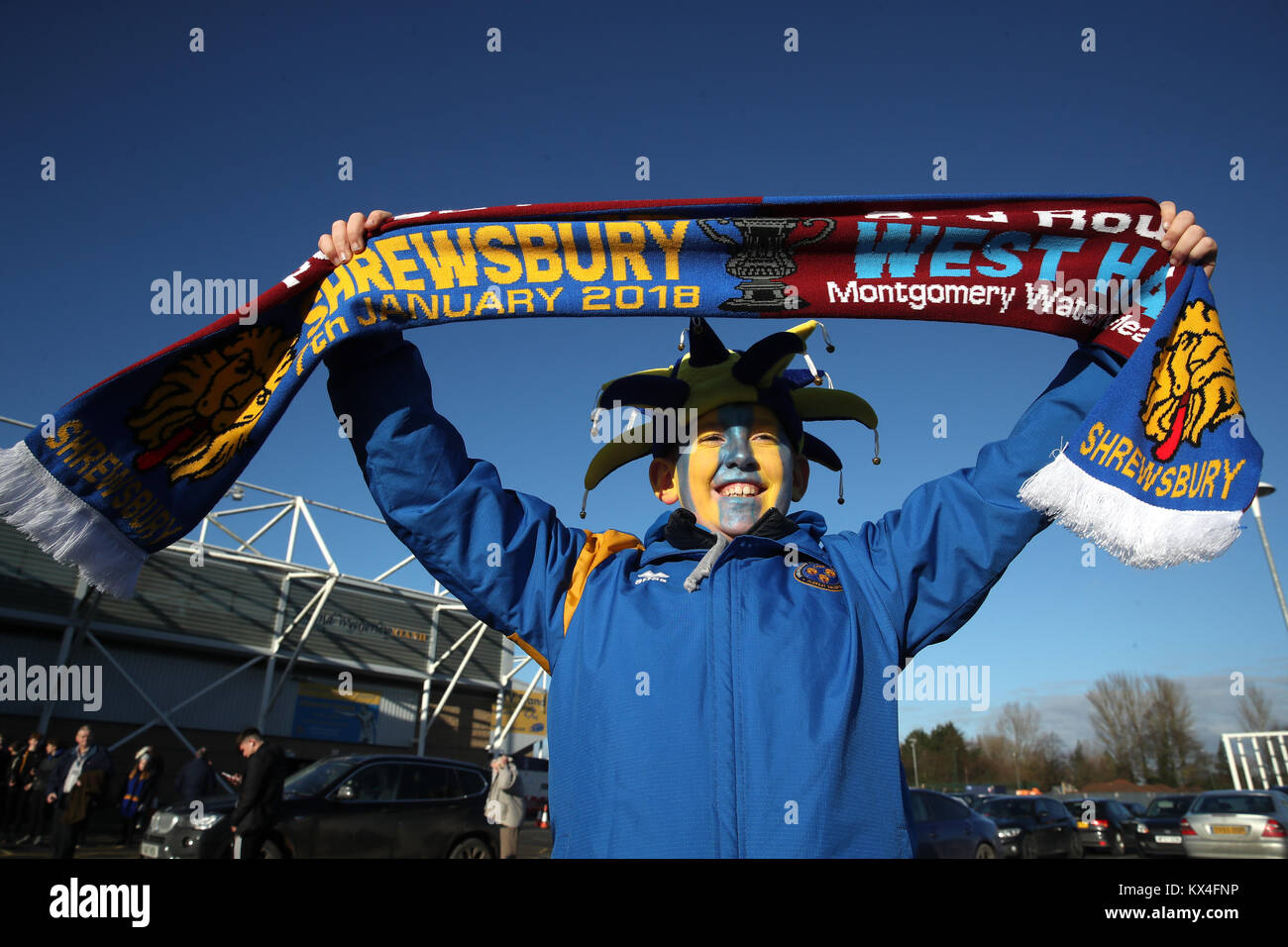 A Shrewsbury Town fan holds up a half and half scarf during the Emirates FA Cup, Third Round match at Montgomery Waters Meadow, Shrewsbury. Stock Photo