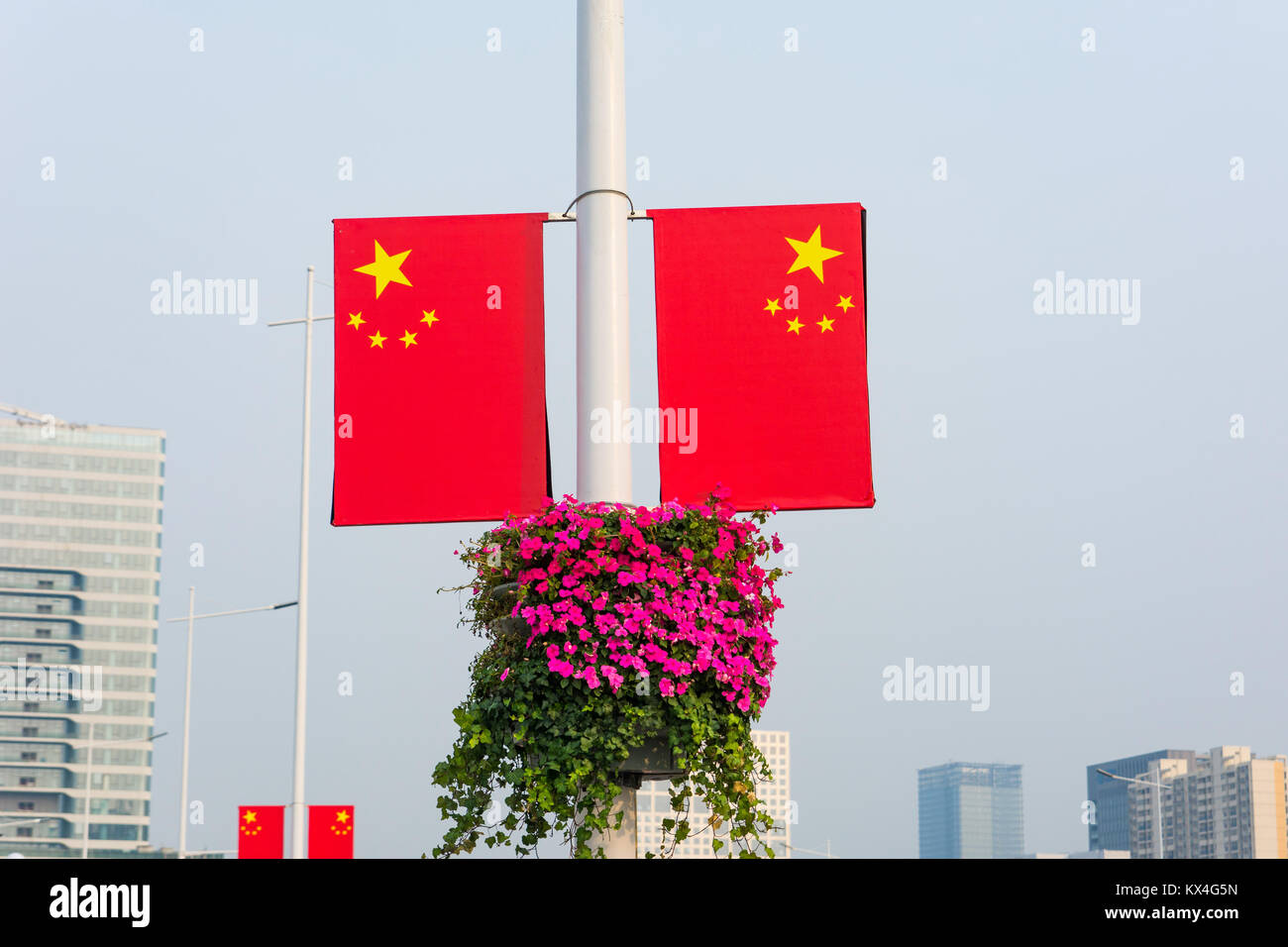 Chinese flag placed on street lights by the road Stock Photo