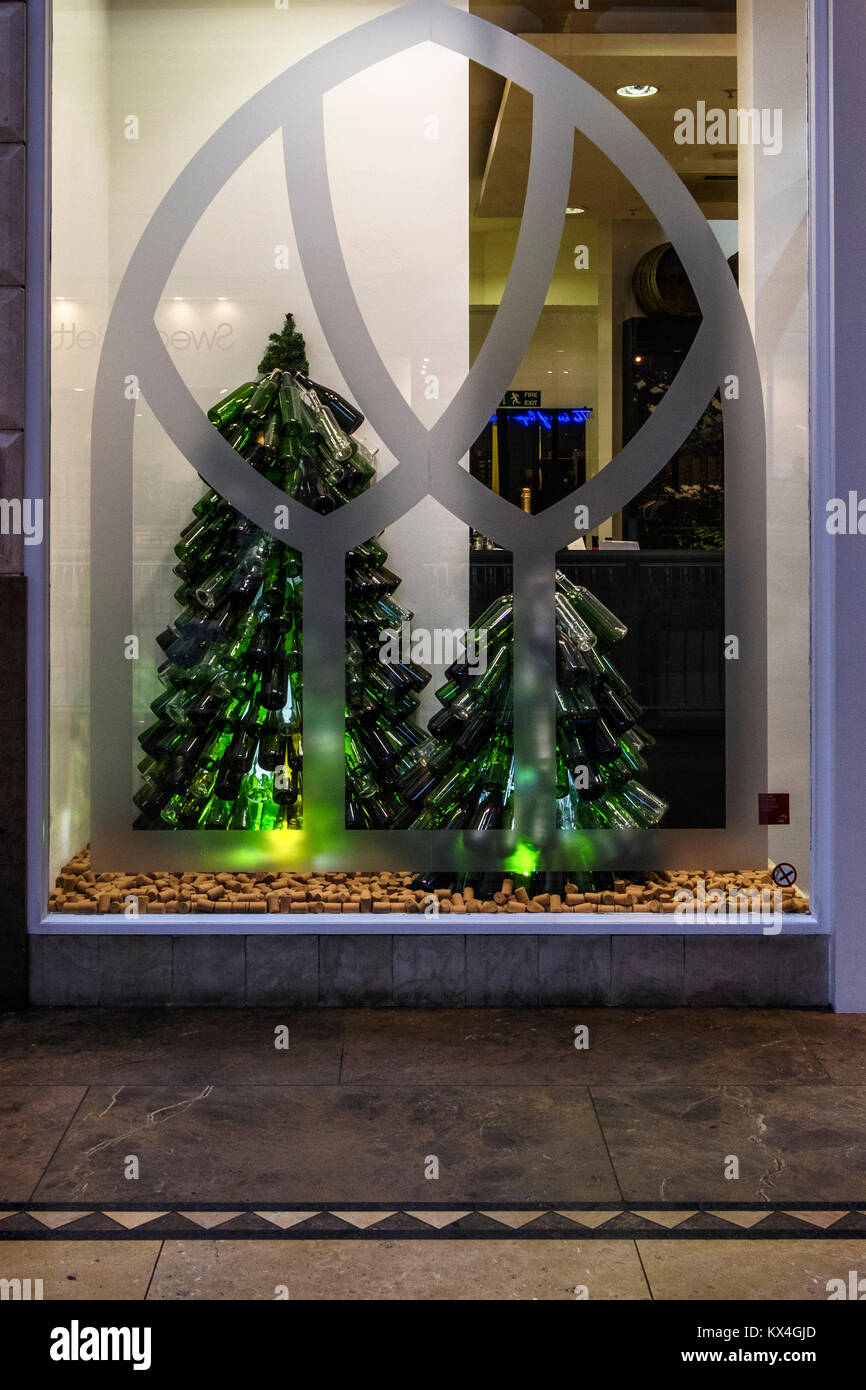 Greenhithe,Kent,England.Bluewater Shopping centre building interior. Shop display window with green bottle Christmas tree Stock Photo