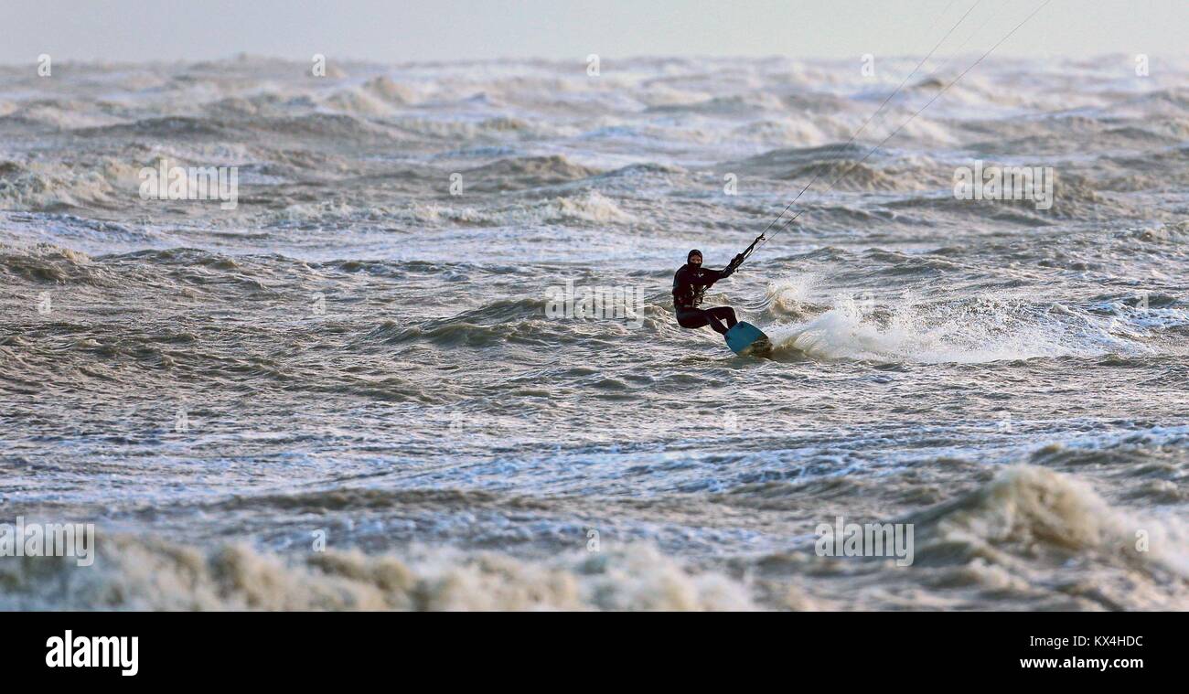 A kitesurfer enjoys the windy conditions on the sea in Greatstone, Kent