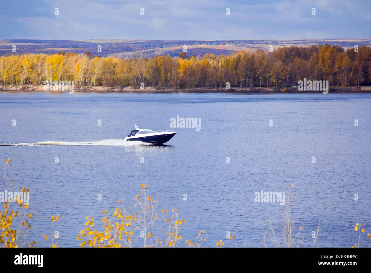 Photo of autumn landscape with motorboat Stock Photo