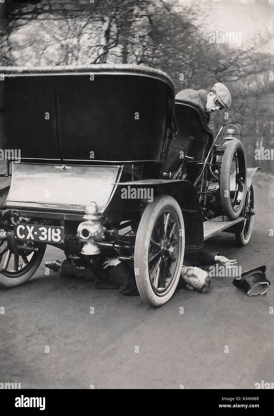 Vintage car accident with humorous overtones, circa 1908. Stock Photo