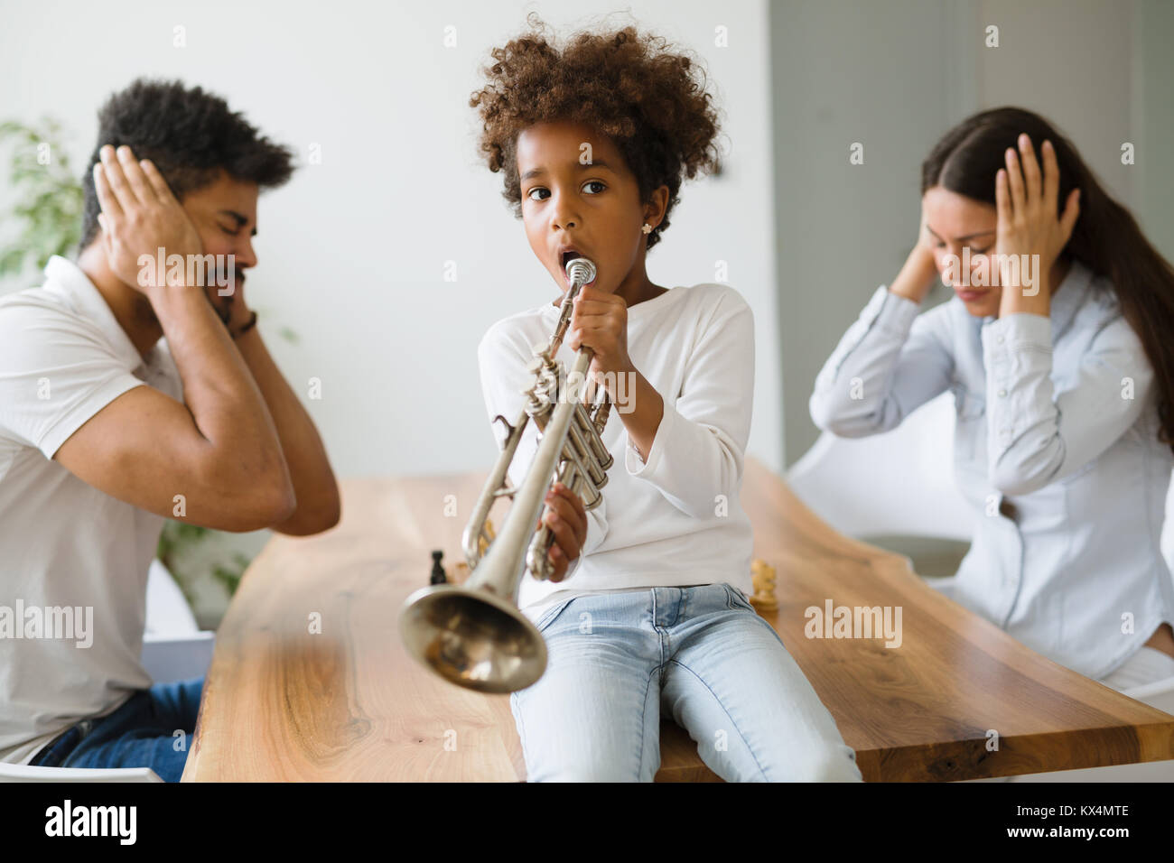 Picture of child making noise by playing trumpet Stock Photo
