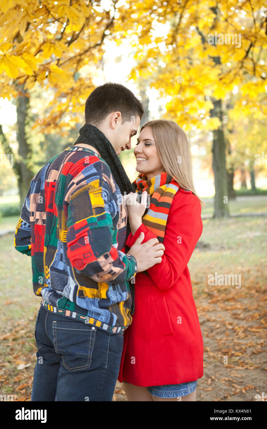 young romantic couple kissing under tree in autumn park Stock Photo - Alamy