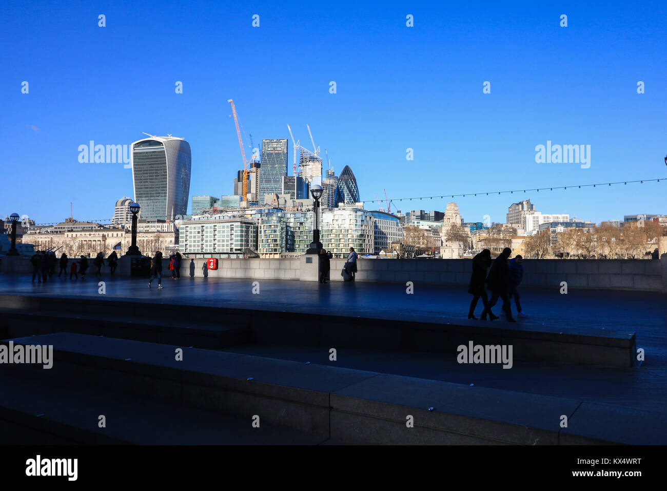 London UK. 7th January 2018. People walk along London Riverside on a sunny cold day as temperatures drop to 4 degrees celsius Credit: amer ghazzal/Alamy Live News Stock Photo