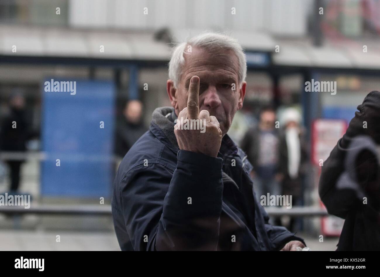 Munich, Bavaria, Germany. 7th Jan, 2018. A bystander from Britain who insulted demonstrators and media representatives with ''go back to where you came from and explicatives. In the wake of new revelations regarding the allegedly irregular investigation of Oury Jalloh's immolation death while in police custody, demonstrations were organized throughout Germany, including 250 participants at Munich's Sendlinger Tor. Credit: ZUMA Press, Inc./Alamy Live News Stock Photo