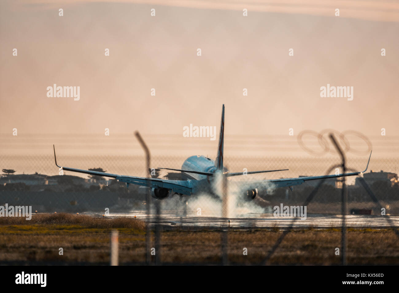 Plane Touching down on a runway Stock Photo