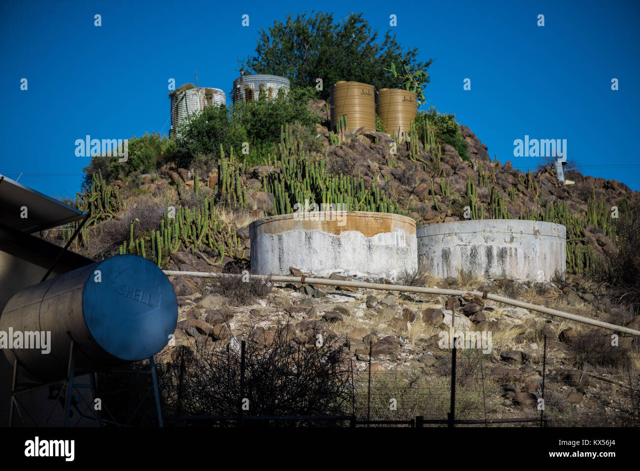 A Royal Dutch Shell fuel tank adjacent to water storage tanks in the Northern Cape, South Africa Stock Photo