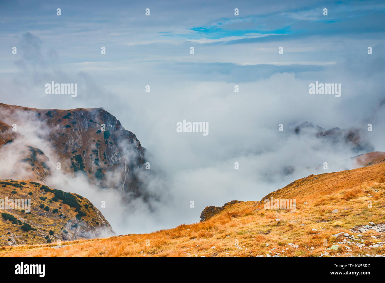 foggy mountain landscape with clouds above the peaks Stock Photo - Alamy