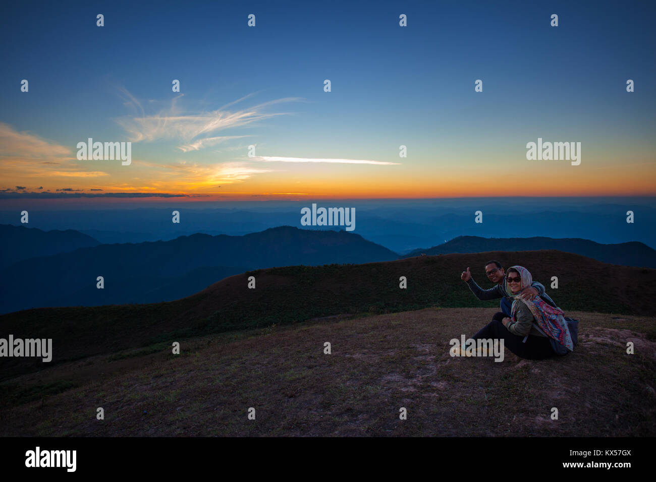 couples of man and woman sitting on top of mountain scene with ...