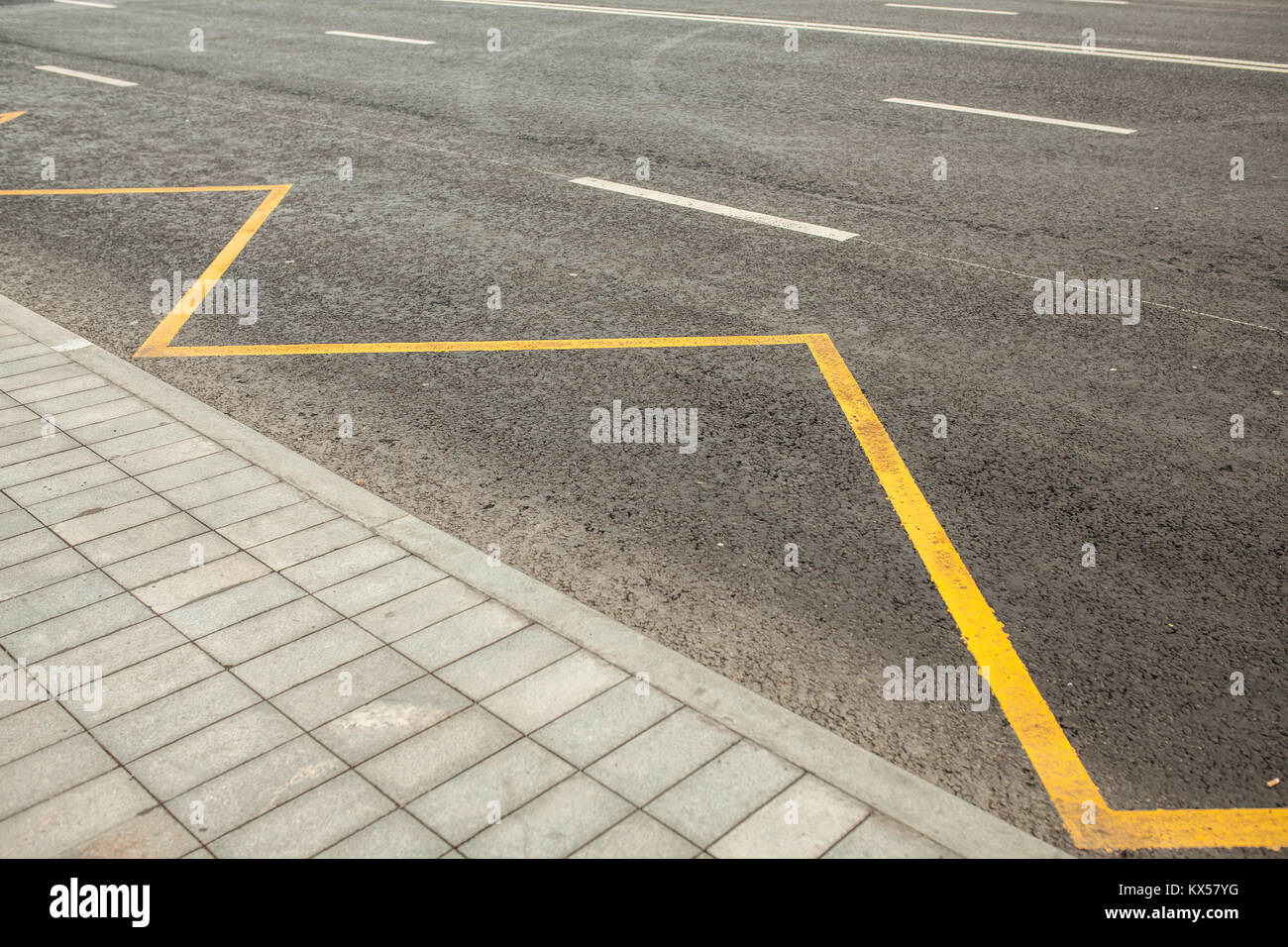 Road markings indicating no stopping or parking bus station Stock Photo