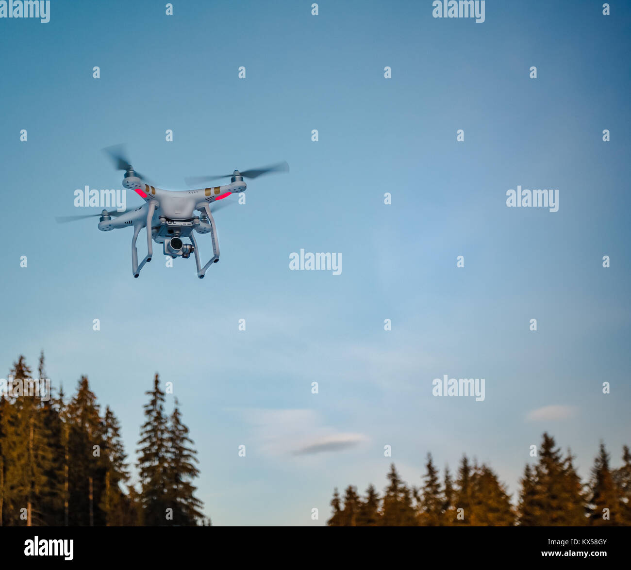 Modern Remote Control Air Drone Fly high with action camera in blue sky ...