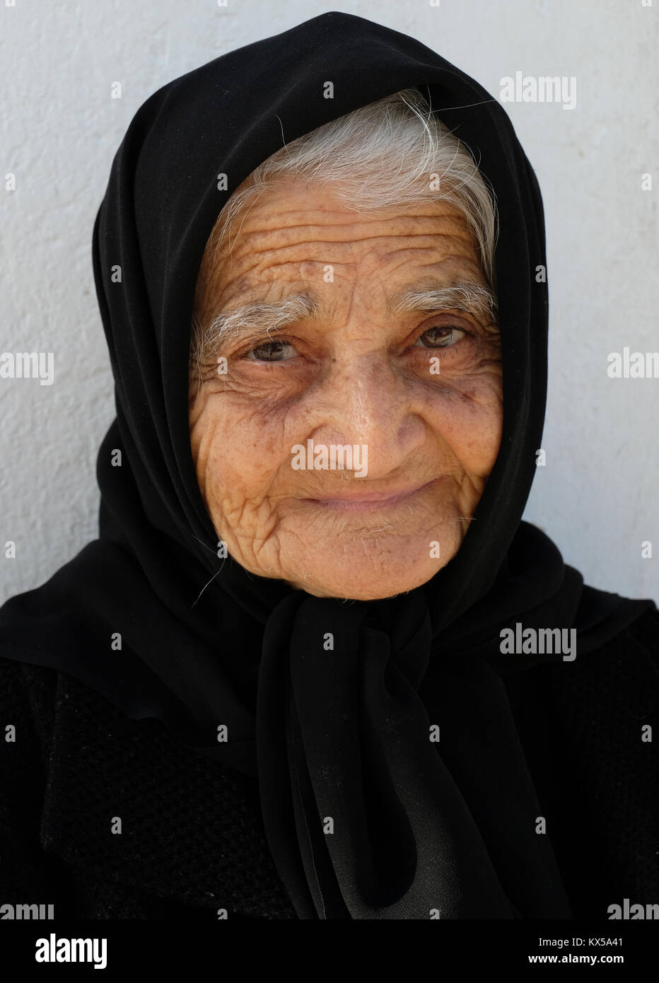 Portrait of a Cypriot woman outside her home in Paphos old town, Cyprus. Stock Photo