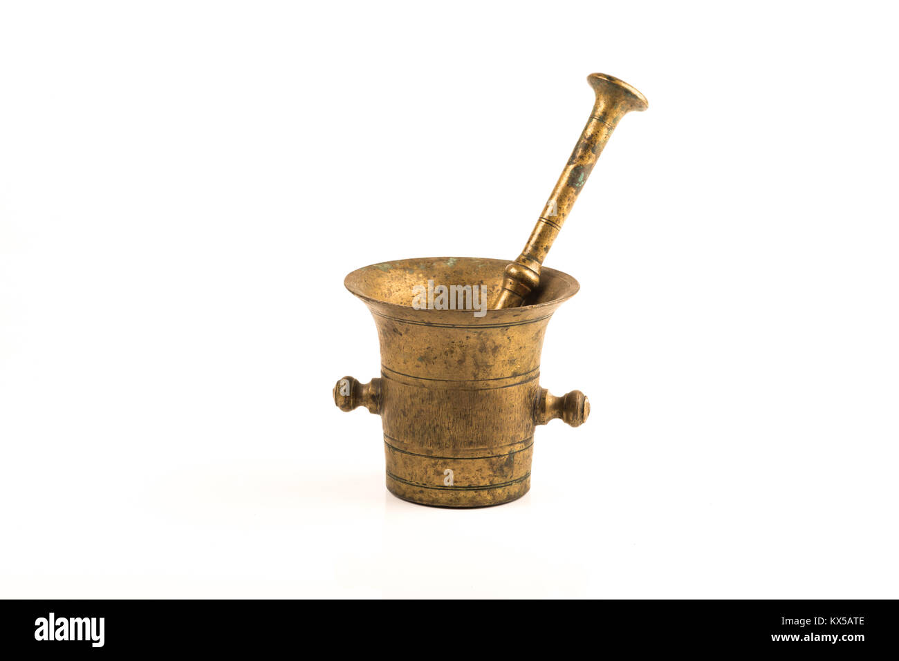 vintage brass grinder over a white background Stock Photo