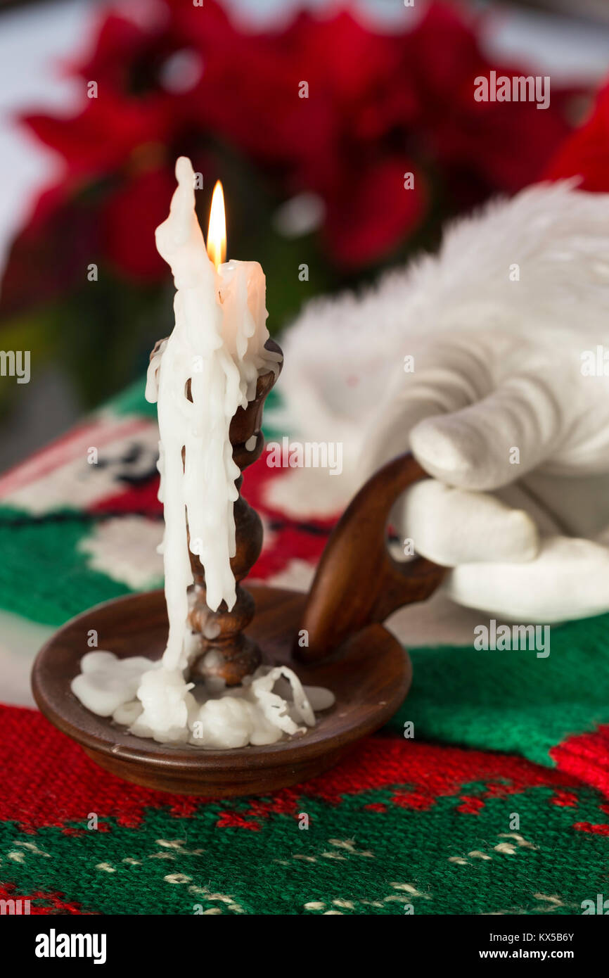 Santa Claus Holds Old Fashioned Candle at Christmastime, USA Stock Photo