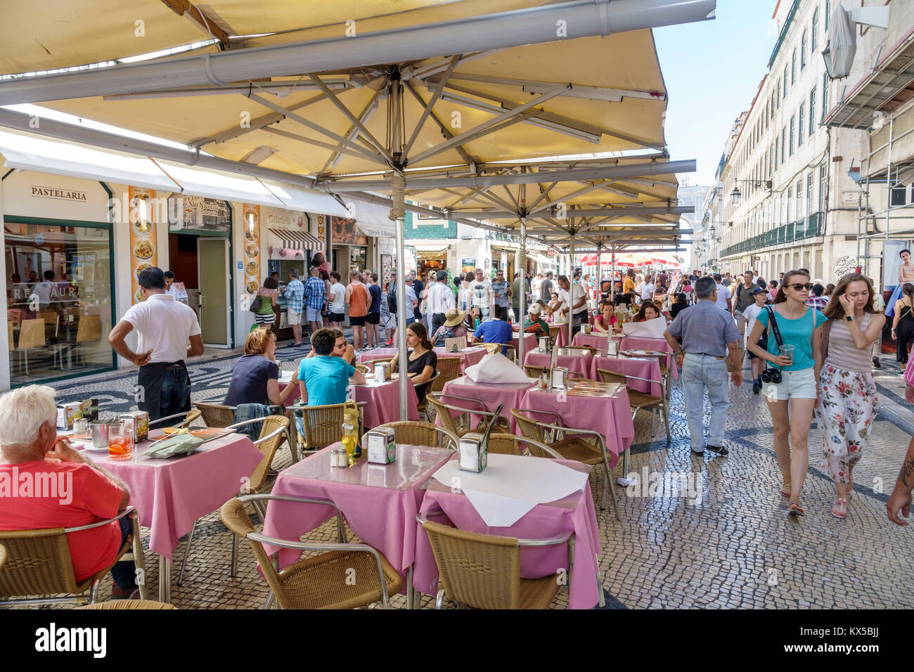 Lisbon Portugal,Baixa,Chiado,historic center,Rua Augusta,pedestrian mall,promenade,cafe,al fresco,sidewalk outside tables dining street,tables,umbrell Stock Photo