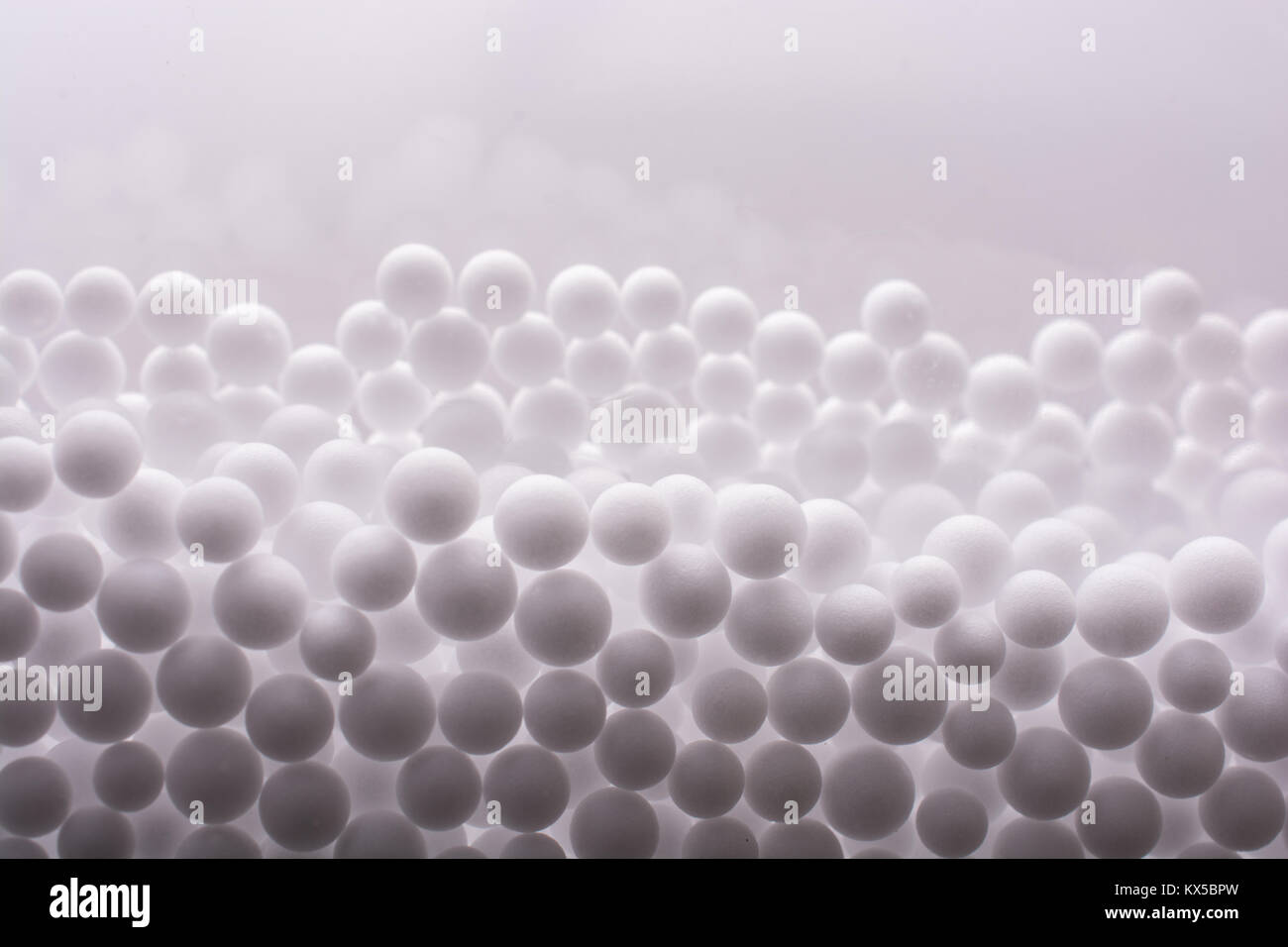 White little polystyrene foam balls as background Stock Photo - Alamy