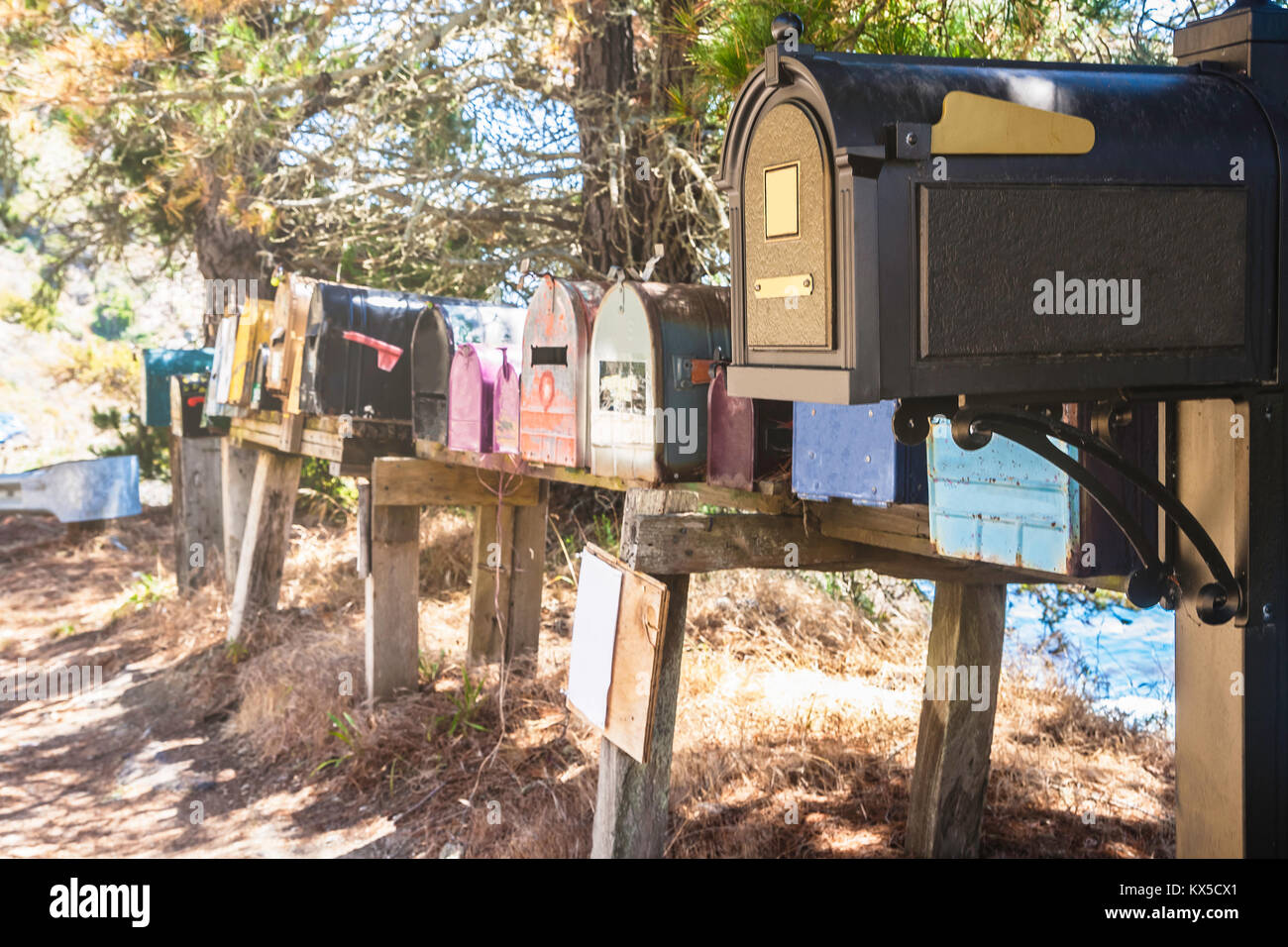 Colorful row of old and typical mailboxes along Big Sur Coast