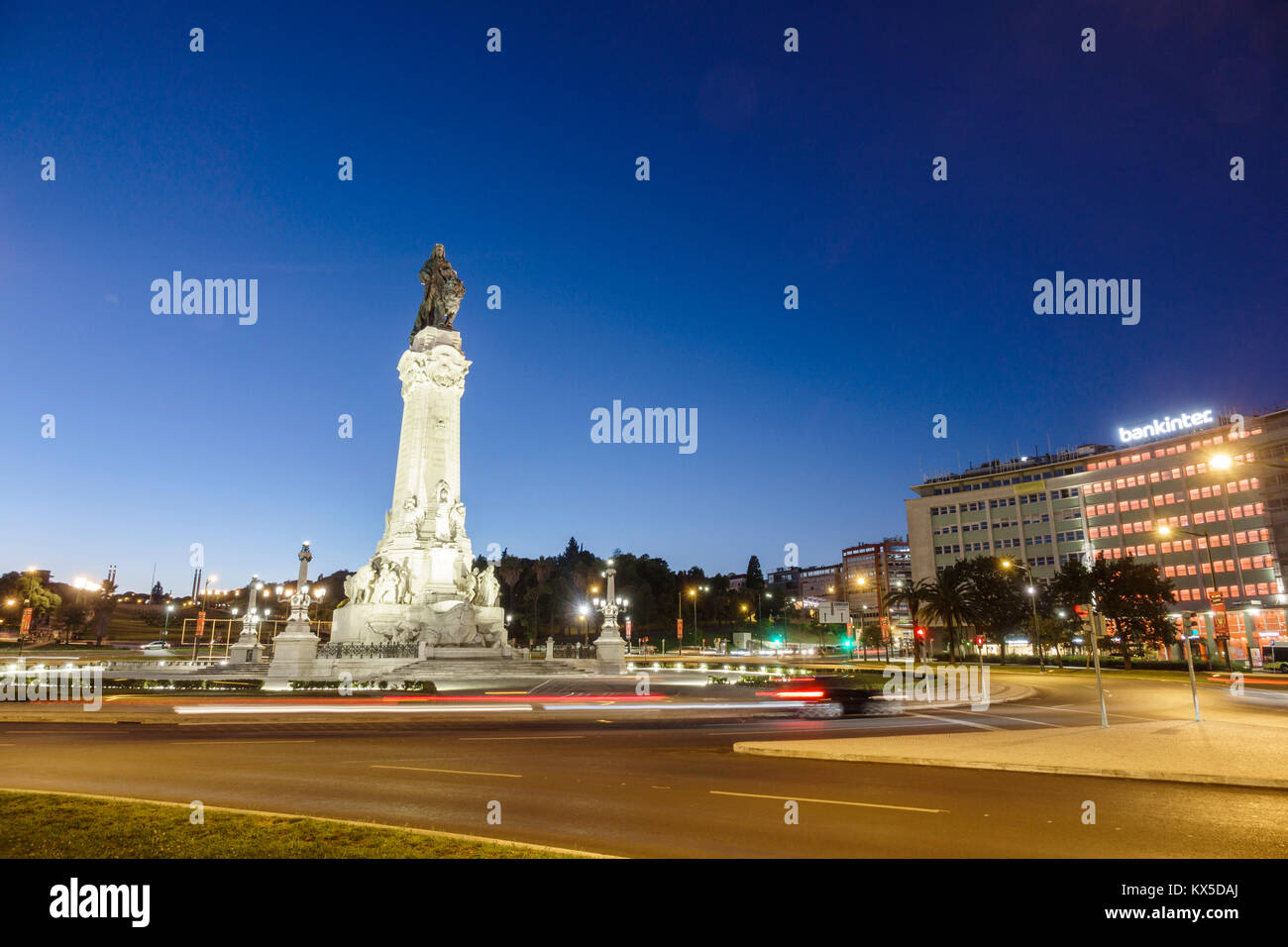 Lisbon Portugal,Praca do Marques de Pombal,roundabout,traffic circle,statue,dusk,car lights,light streaks,night evening,Hispanic,immigrant immigrants, Stock Photo