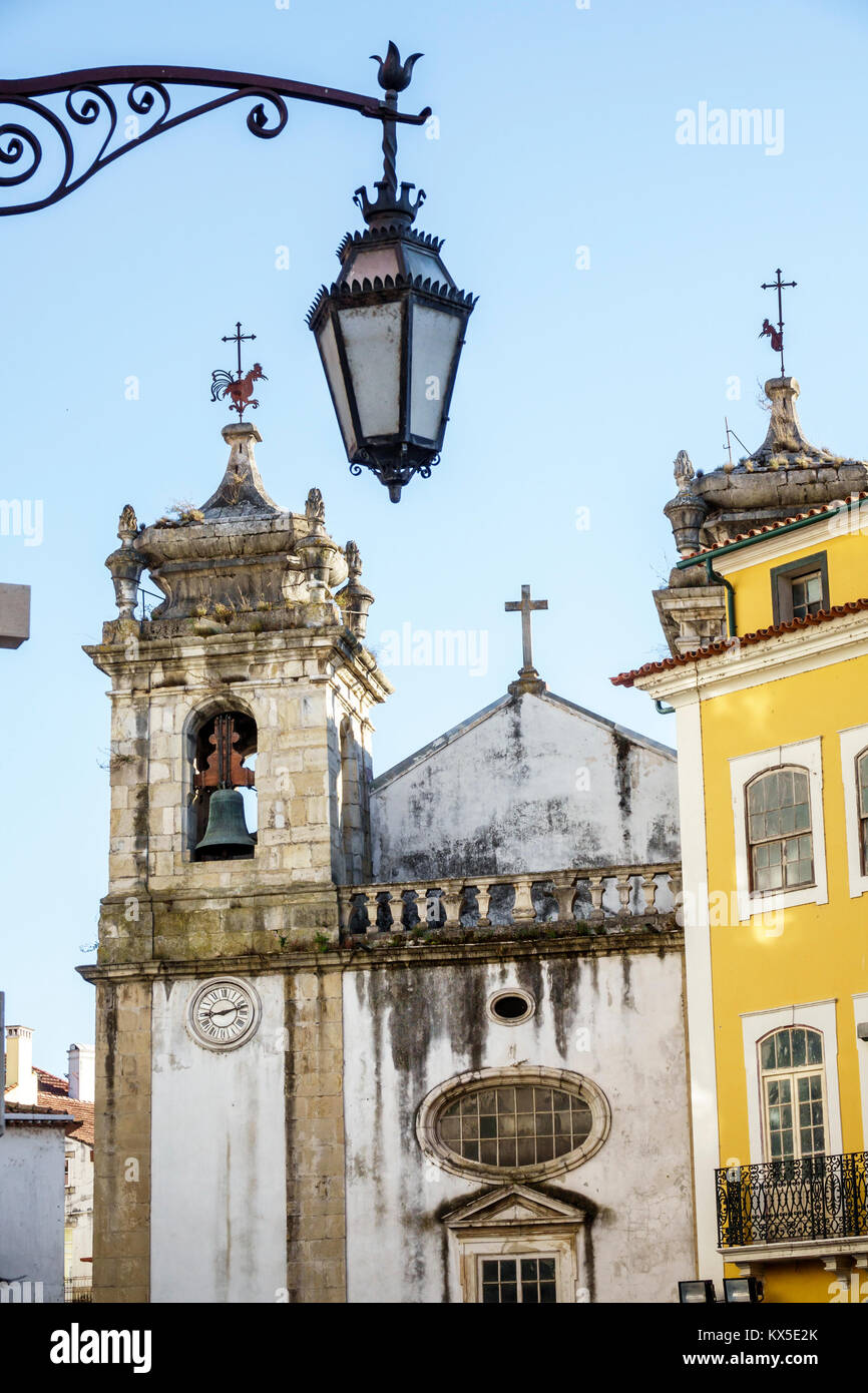 Coimbra Portugal,historic center,Igreja de Sao Bartolomeu,Saint Bartholomew,Catholic Church,bell tower,ornate lamp,cross,Hispanic Latin Latino ethnic Stock Photo