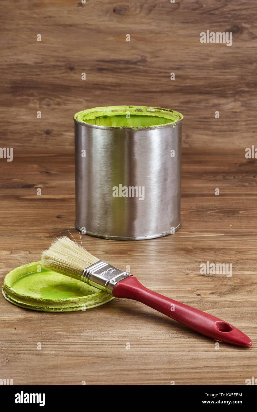 green paint can with a brush on a rustic wooden background Stock Photo
