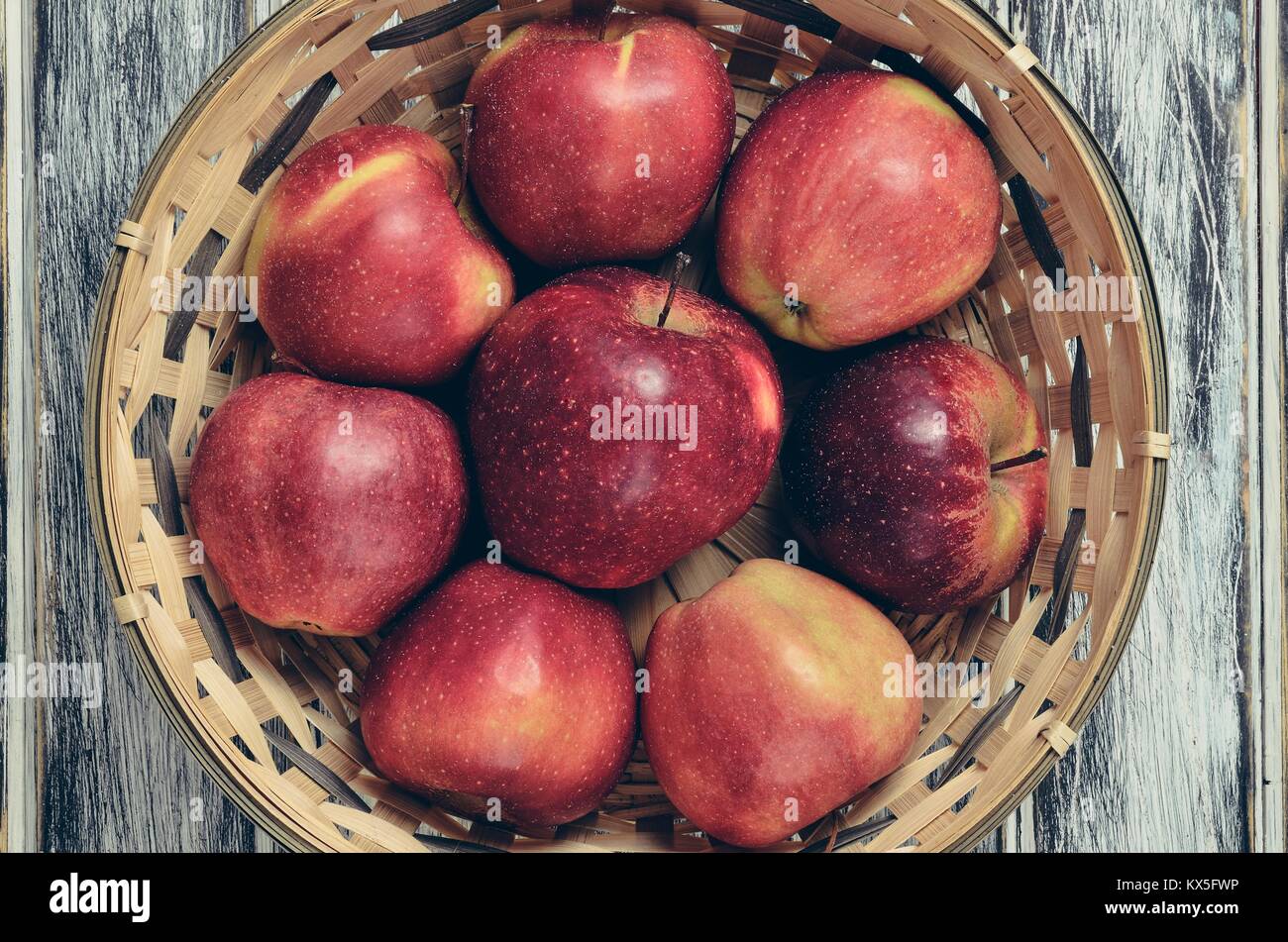 Fresh red apples. Natural apples in a wicker basket. Stock Photo