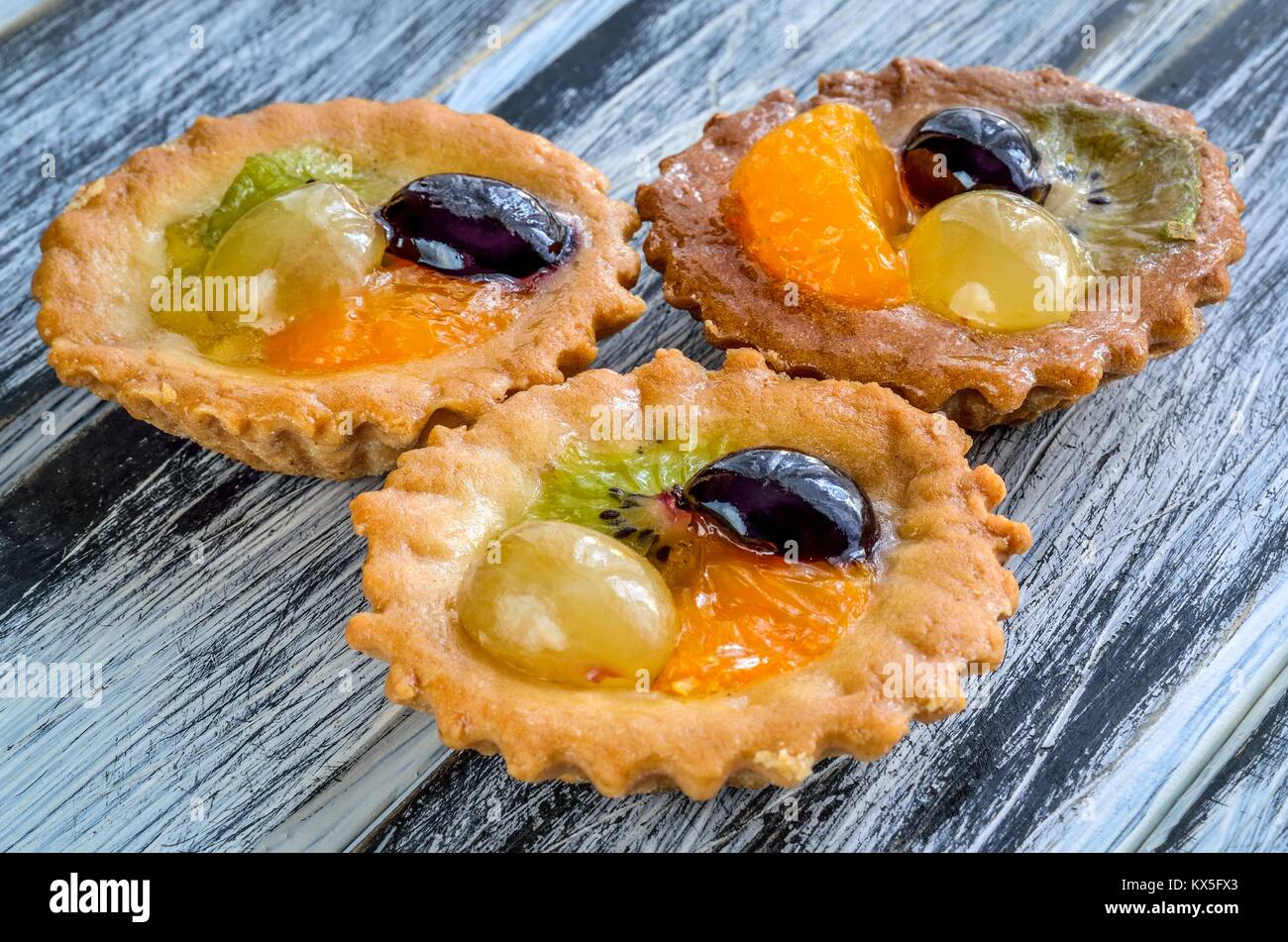 Sweet delicious meal. Muffins with colorful and fresh fruits. Stock Photo