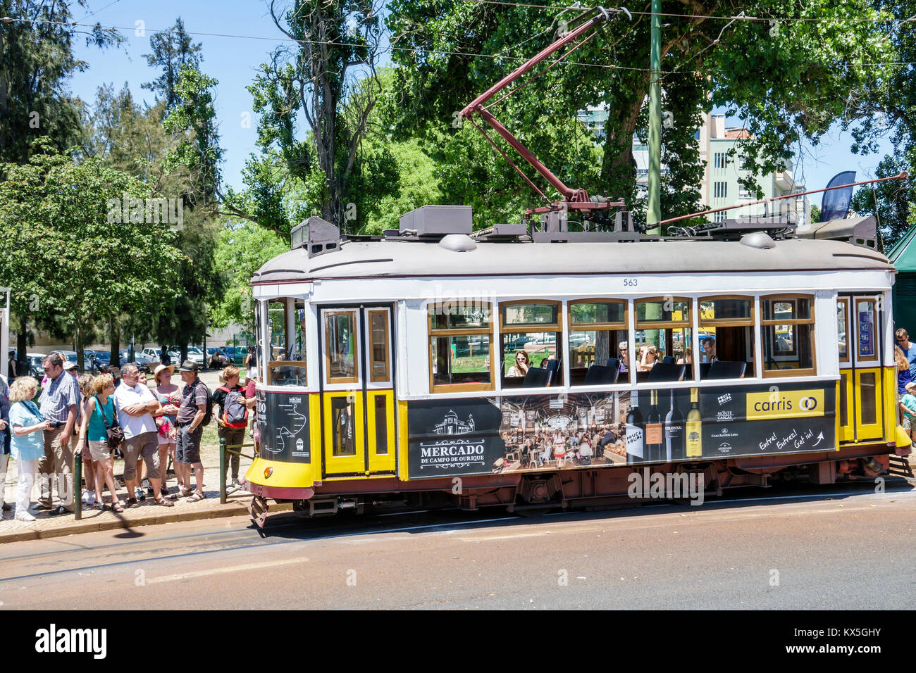 Lisbon Portugal,Lapa,Estrela,heritage tram,trolley,Tram 25,Prazeres,man men male,woman female women,waiting to board,line,queue,passengers riders,Hisp Stock Photo