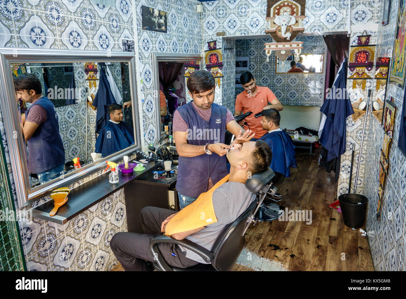 Lisbon Portugal,historic center,centre,Mouraria,Moorish ghetto,medieval quarter,neighborhood,barbershop,Hispanic,immigrant immigrants,man men male,sha Stock Photo