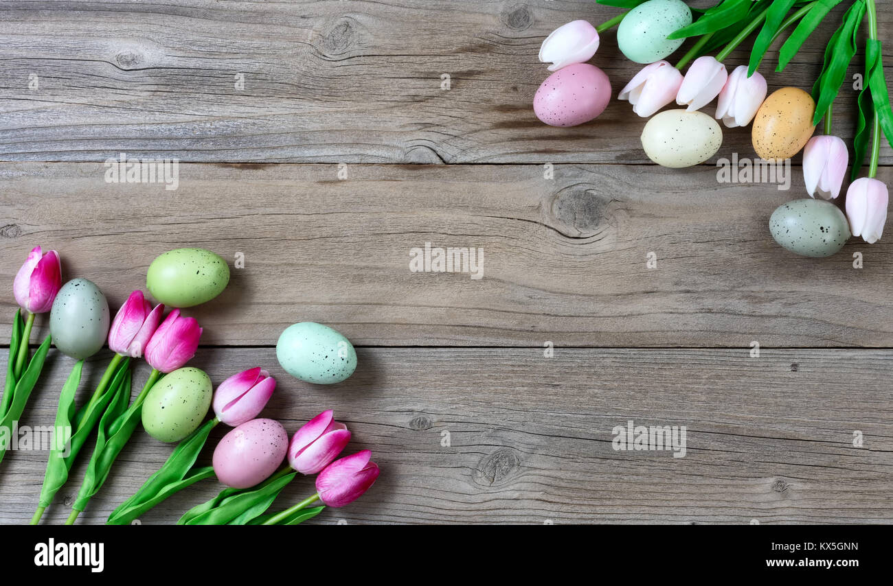Tulips and colorful eggs on rustic wooden boards for Easter Background ...