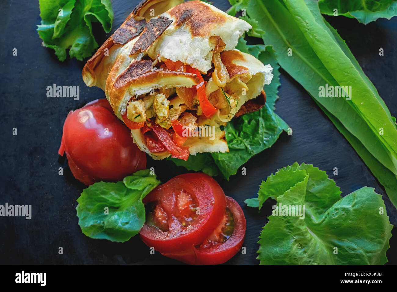 Mexican tortilla with chicken , pepper and tomatoes. Selective focus. Close-up. Stock Photo