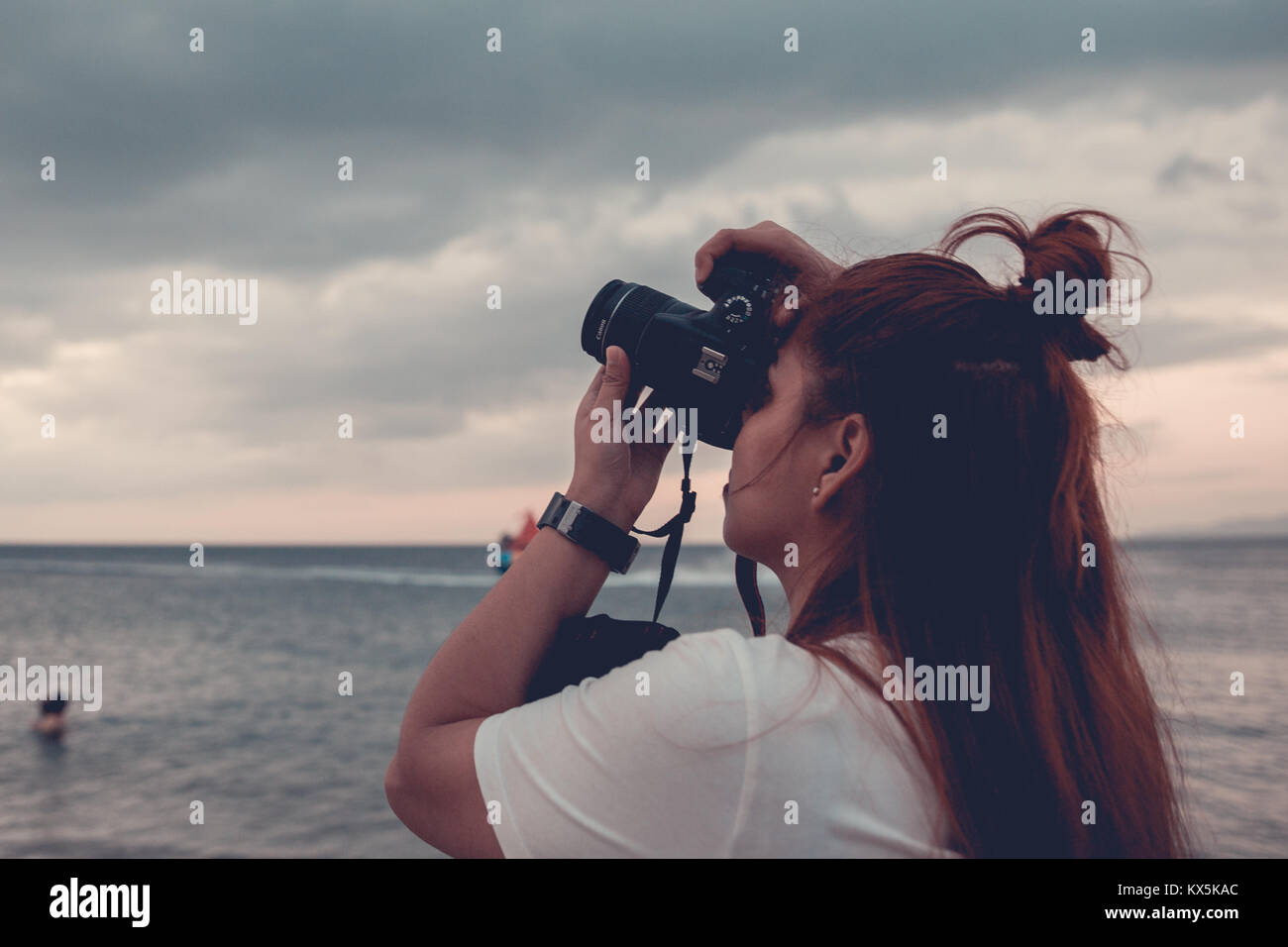 Girl Holding A Camera Taking A Shot At The Sky Stock Photo Alamy