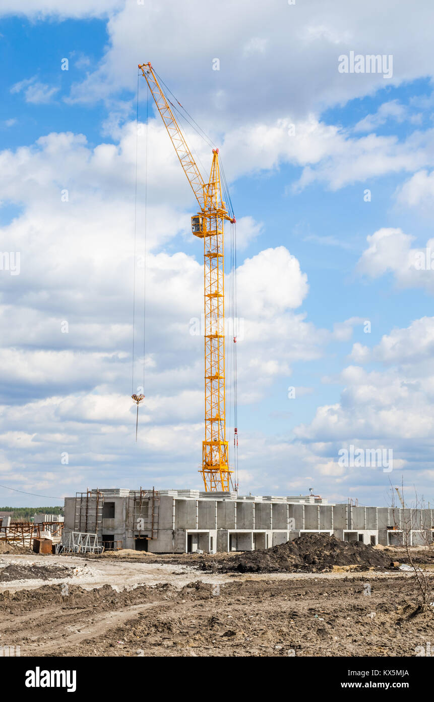 Silhouette Lift crane on construction site with blue sky and white cloud Stock Photo