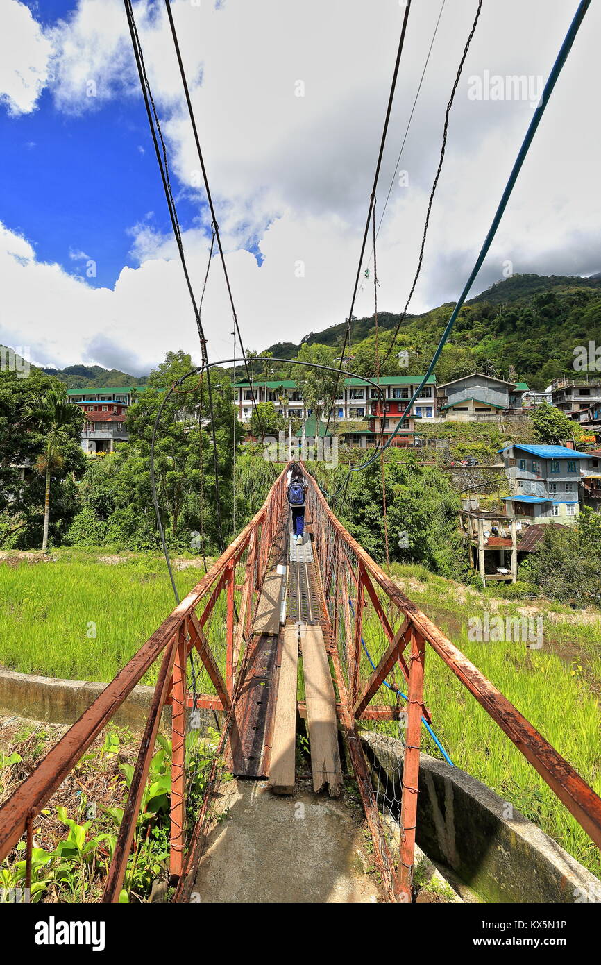 The suspension or hanging bridge in Banaue connects the downtown market area with the Batad road-used by many students to go to their school across th Stock Photo