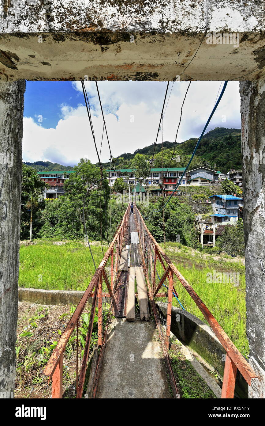 The suspension or hanging bridge in Banaue connects the downtown market area with the Batad road-used by many students to go to their school across th Stock Photo