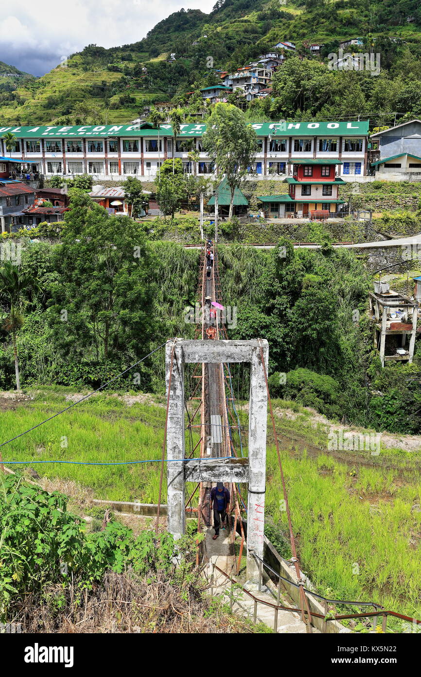 Banaue, Philippines-October 6, 2016: The suspension or hanging bridge connects downtown market area with Batad road-used by students to go to their sc Stock Photo