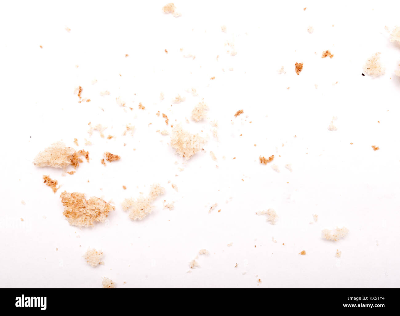 Crumbled pieces of bread on white background Stock Photo - Alamy