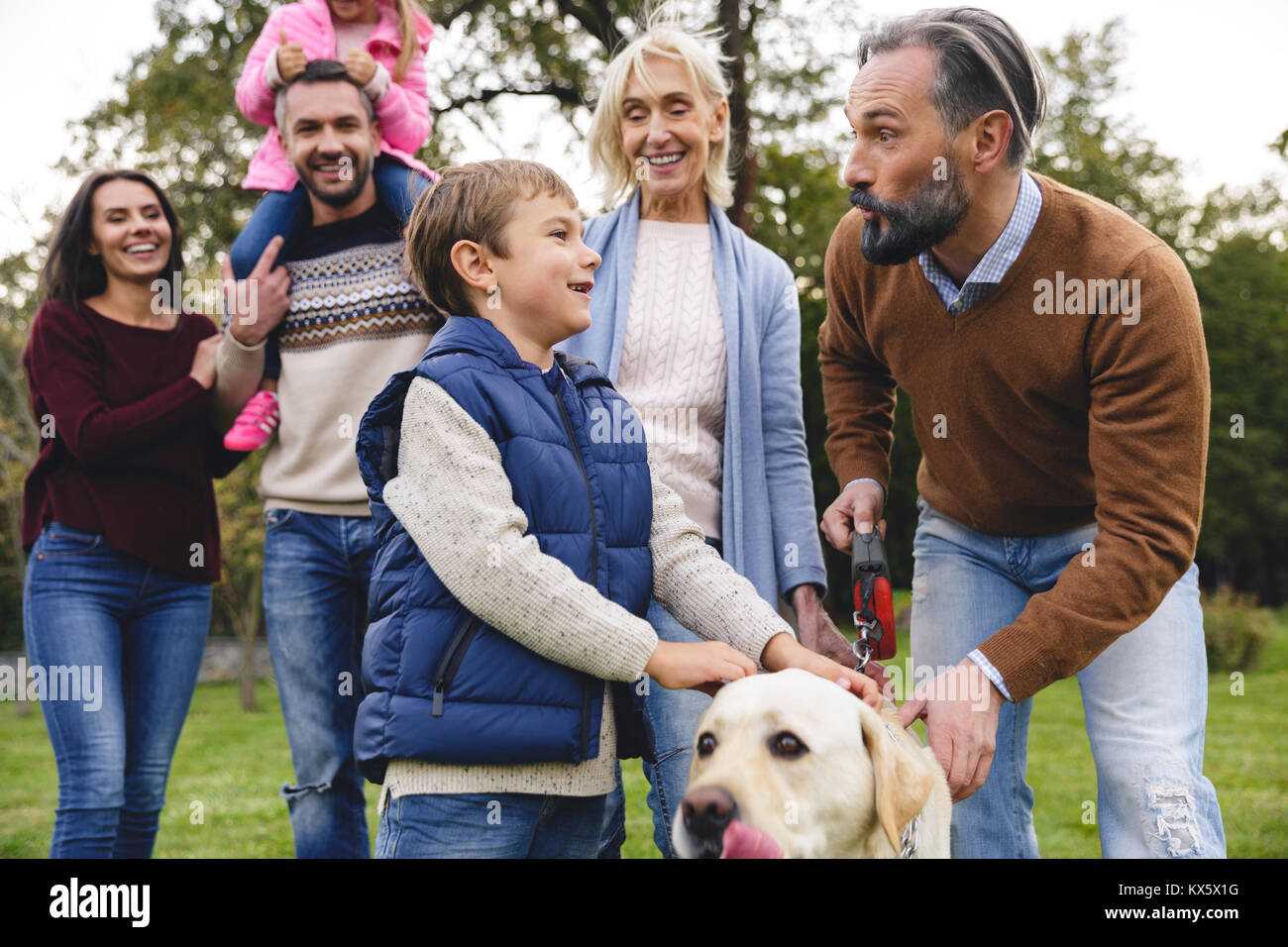 Big happy family with their dog in the park on a sunny day Stock Photo ...